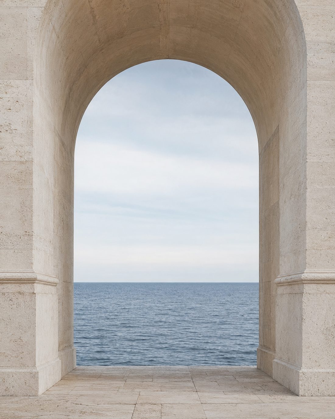 A stone archway opening onto a calm sea horizon